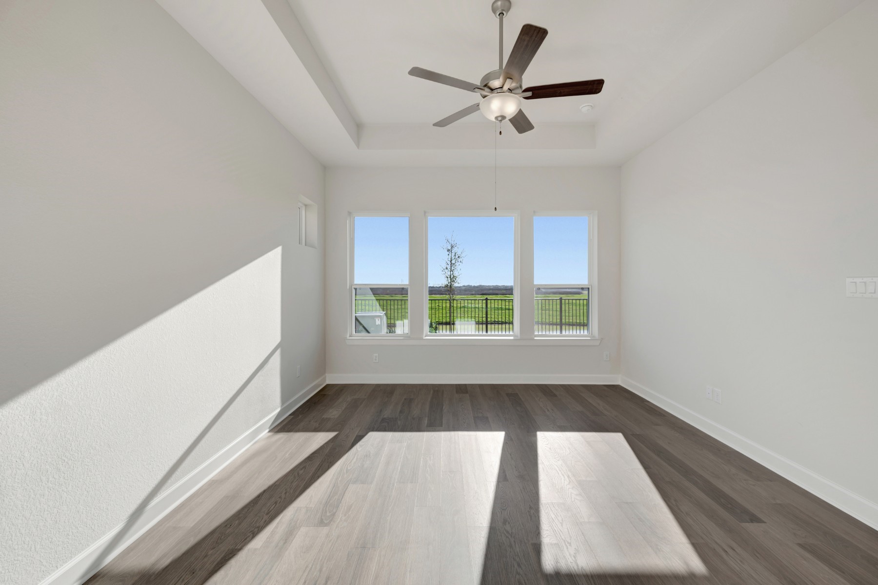 646 Walnut Br Drive Rosenberg, TX 77471 - Photo 39 of 46 an empty room with wooden floor fan and windows