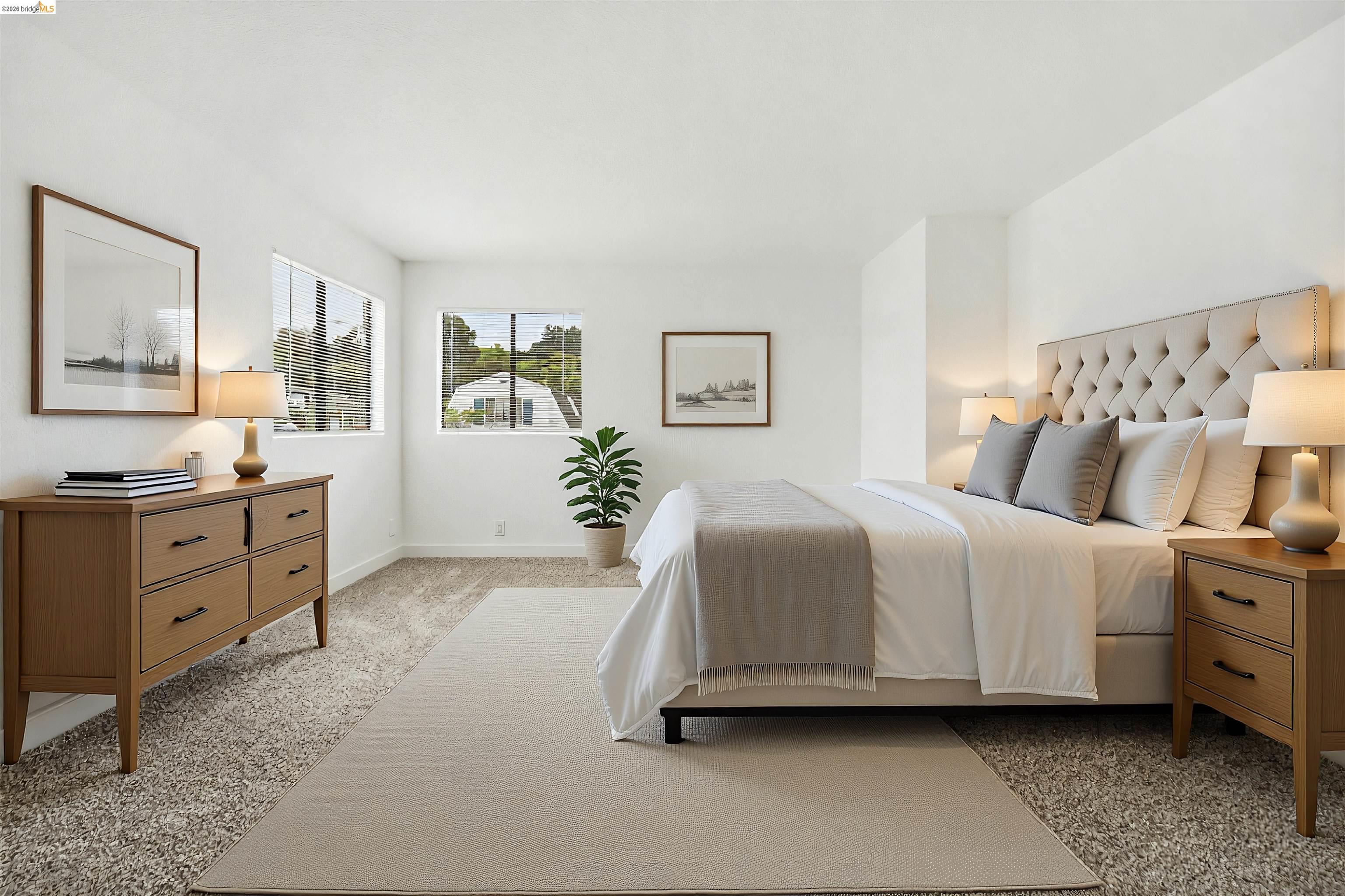 10933 Julius Street, Unit D Oakland, CA 94605 - Photo 17 of 28 a spacious bedroom with a bed and a couch