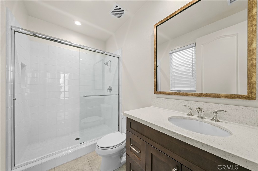 52 Eider Run Irvine, CA 92618 - Photo 35 of 46 a bathroom with a granite countertop sink a toilet and shower