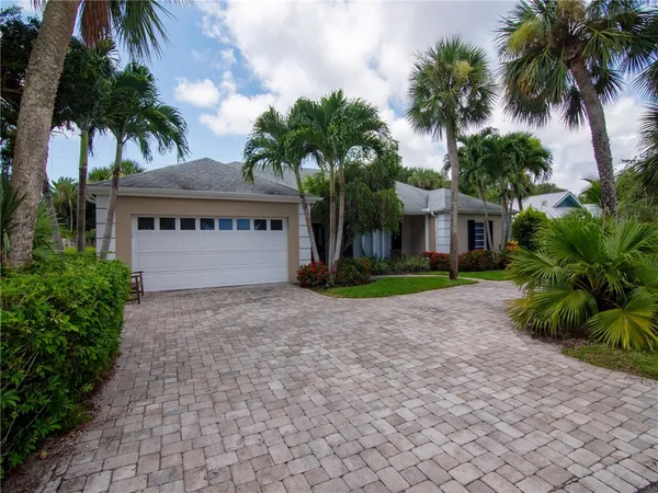 a house with palm tree in front of it