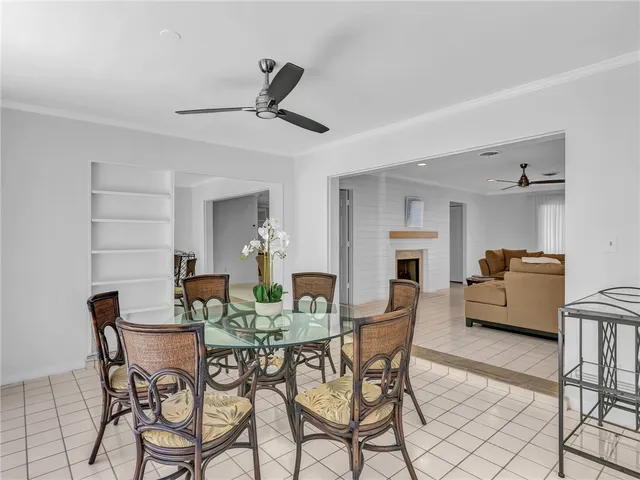 a view of a dining room with furniture and a chandelier
