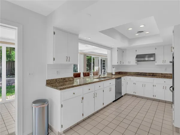 a large white kitchen with a sink