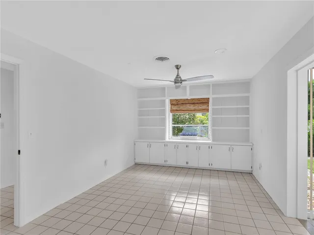 an empty room with a empty space and windows