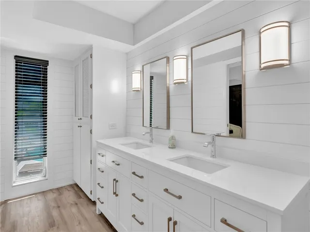 a bathroom with a double vanity sink and mirror