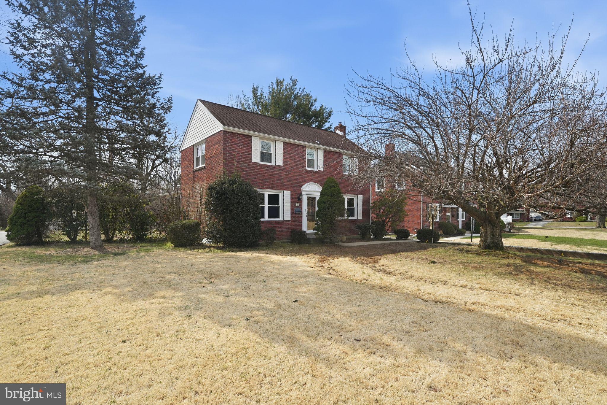 a front view of a house with a yard covered with snow