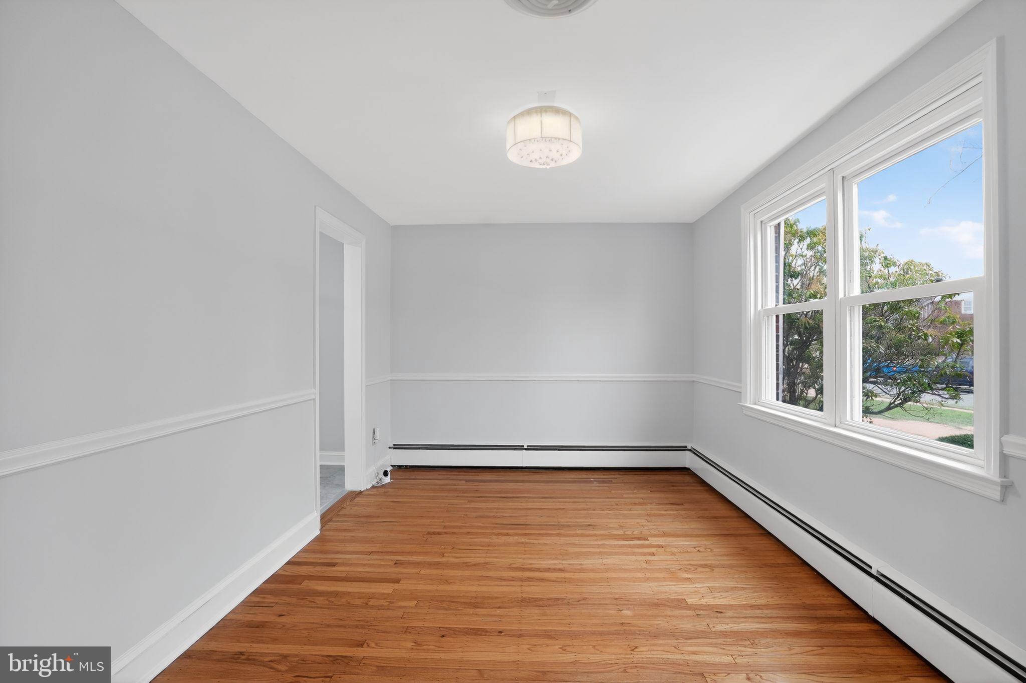 616 Hey Lane Springfield, PA 19064 - Photo 11 of 35 a view of empty room with wooden floor and fan