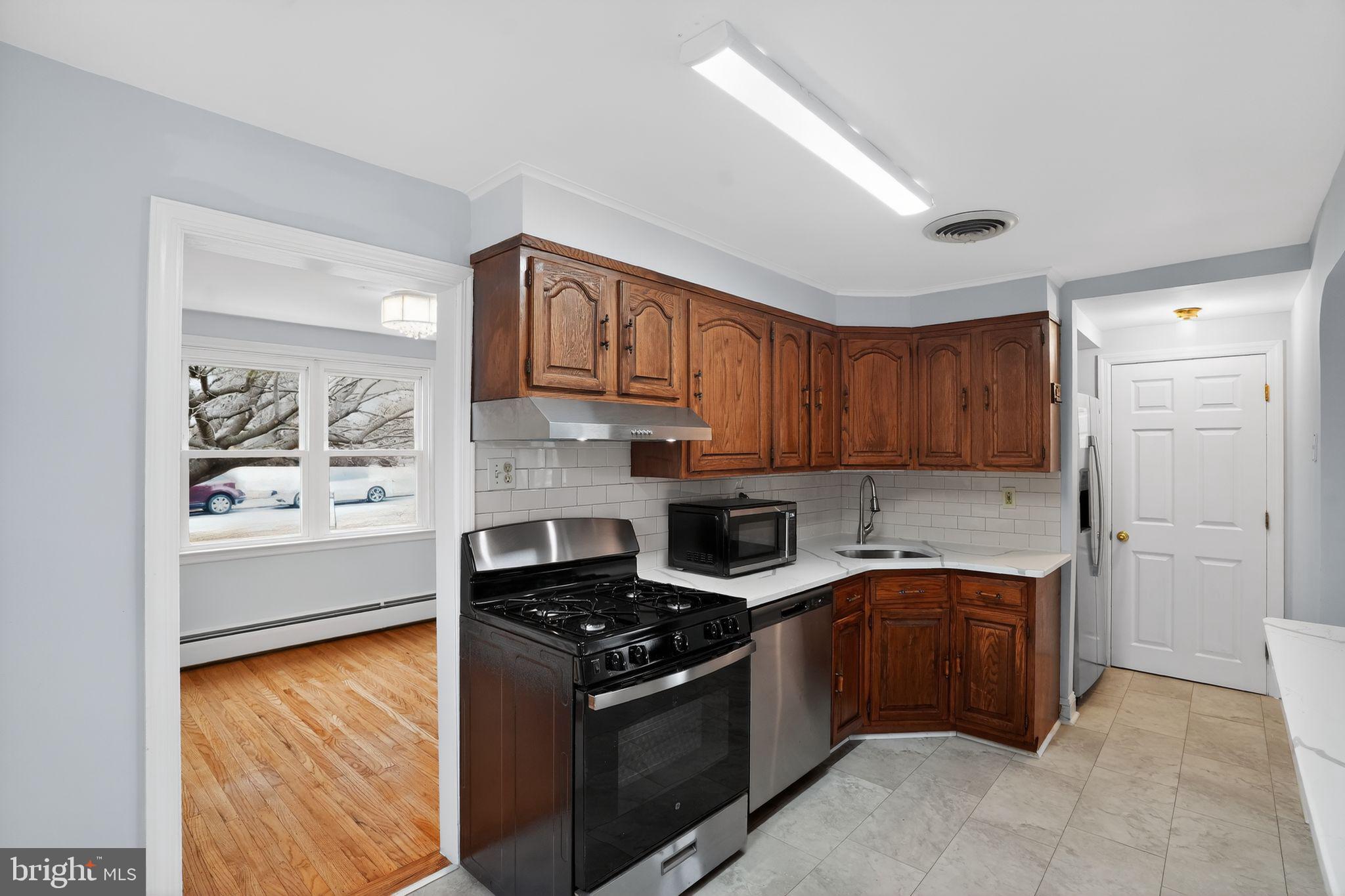 616 Hey Lane Springfield, PA 19064 - Photo 13 of 35 a kitchen with stainless steel appliances granite countertop a stove a sink and a refrigerator