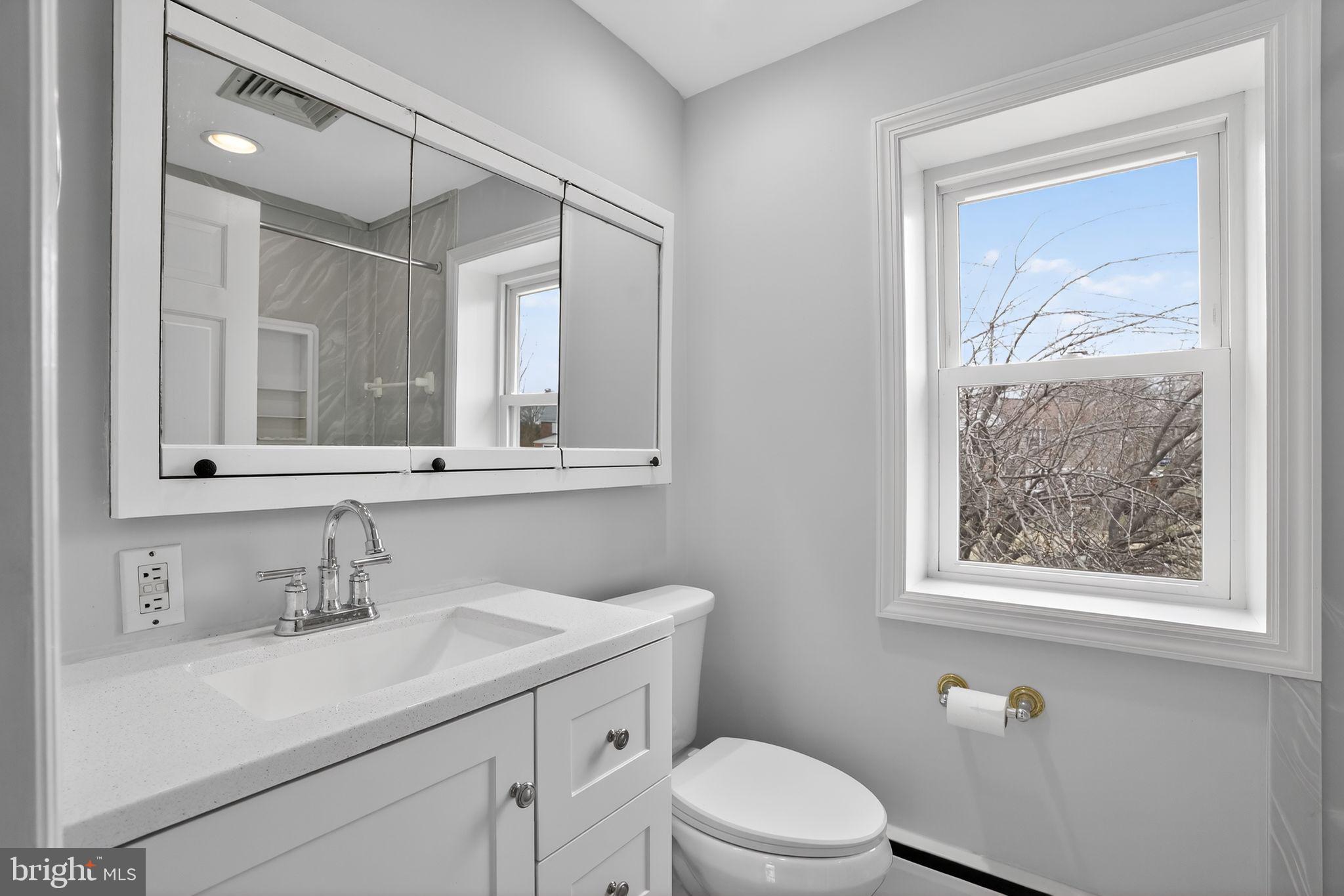 616 Hey Lane Springfield, PA 19064 - Photo 26 of 35 a bathroom with a toilet a sink a vanity and mirror