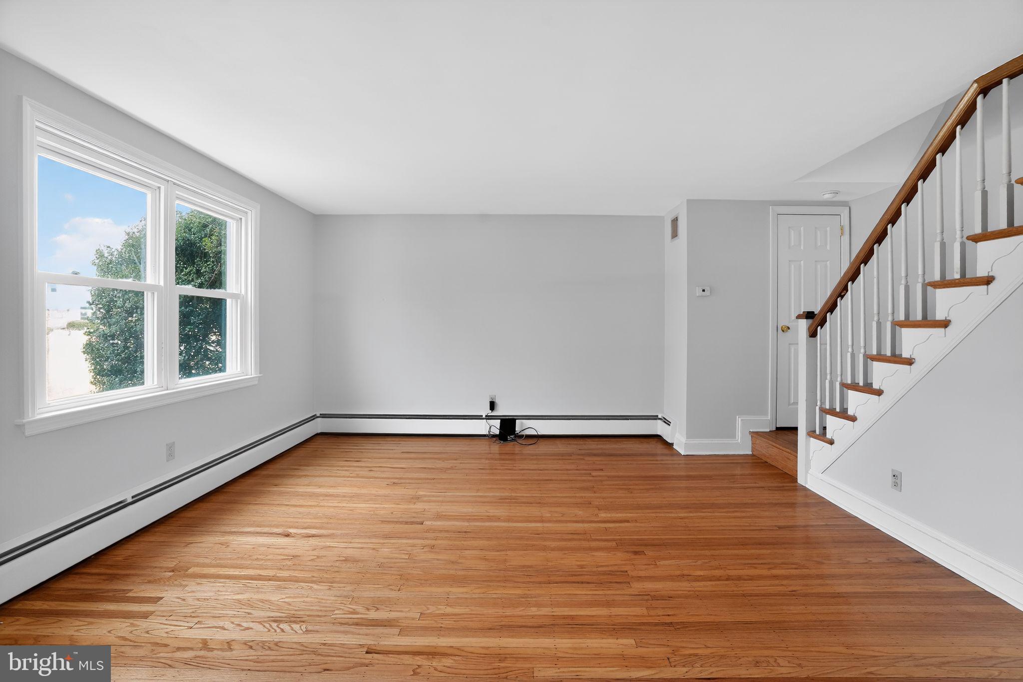 616 Hey Lane Springfield, PA 19064 - Photo 8 of 35 a view of an empty room with wooden floor and a window