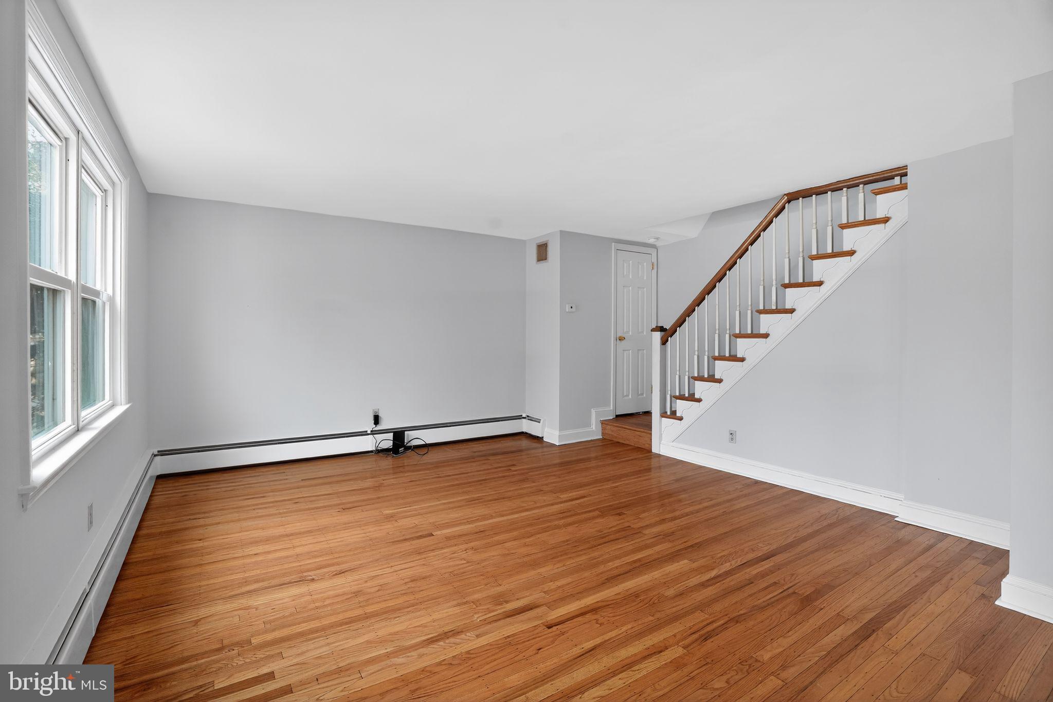 616 Hey Lane Springfield, PA 19064 - Photo 9 of 35 a view of an empty room with wooden floor and a window