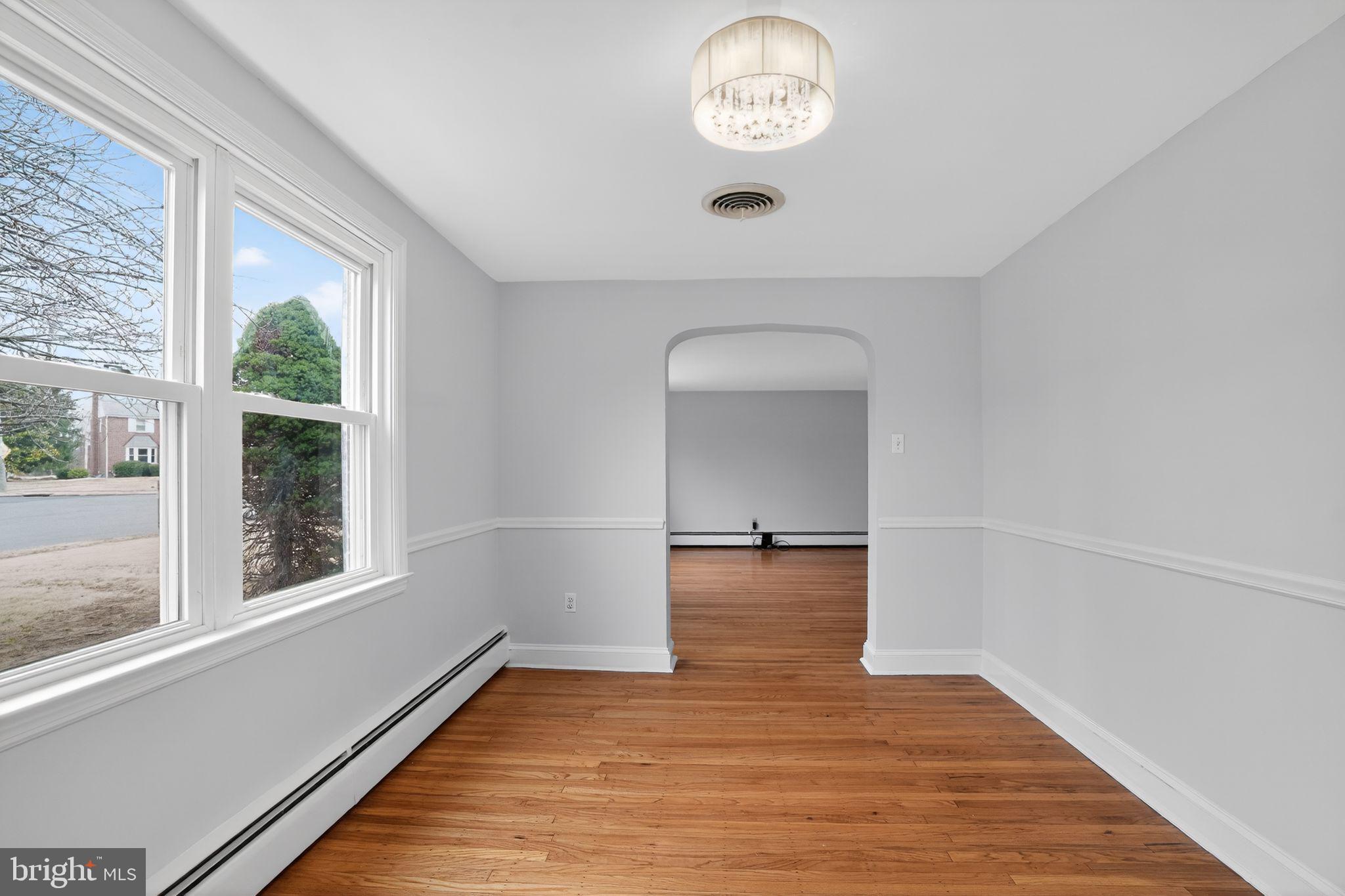 616 Hey Lane Springfield, PA 19064 - Photo 10 of 35 an empty room with wooden floor and windows