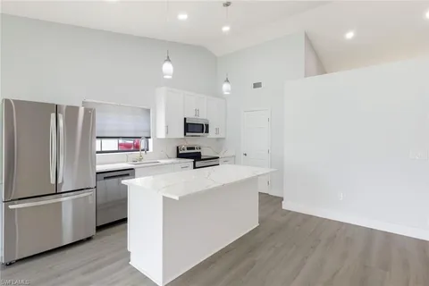 a kitchen with stainless steel appliances a refrigerator stove microwave and sink