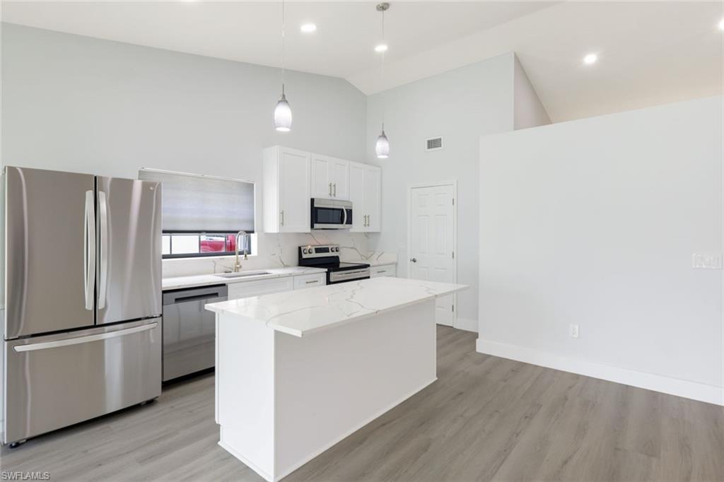 12800 Eagle Pointe Circle Fort Myers, FL 33913 - Photo 12 of 28 a kitchen with stainless steel appliances a refrigerator stove microwave and sink