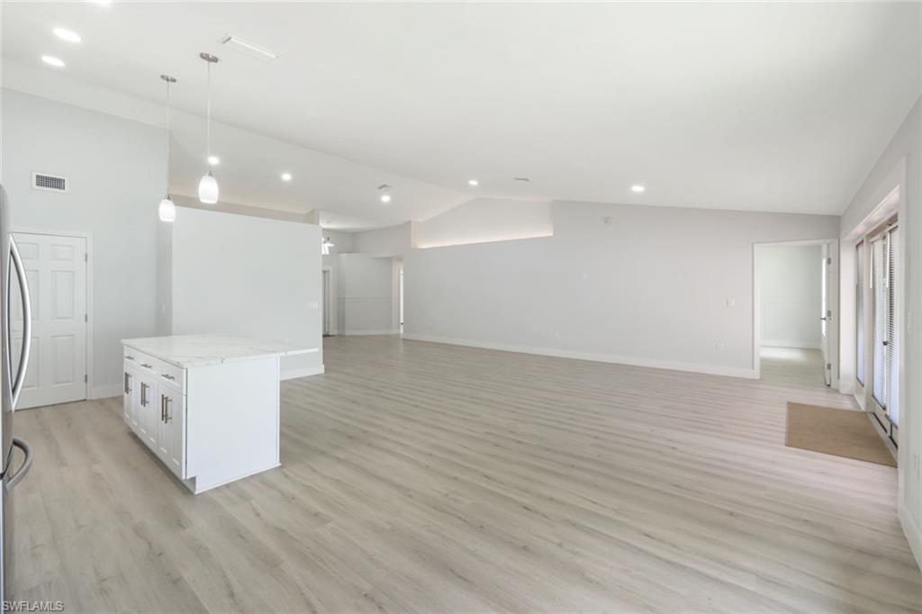 12800 Eagle Pointe Circle Fort Myers, FL 33913 - Photo 13 of 28 an empty room with wooden floor and windows