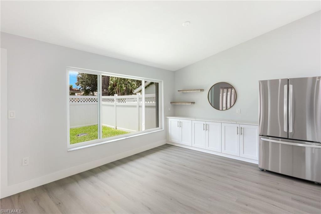 12800 Eagle Pointe Circle Fort Myers, FL 33913 - Photo 14 of 28 a view of an empty room with a window and wooden floor