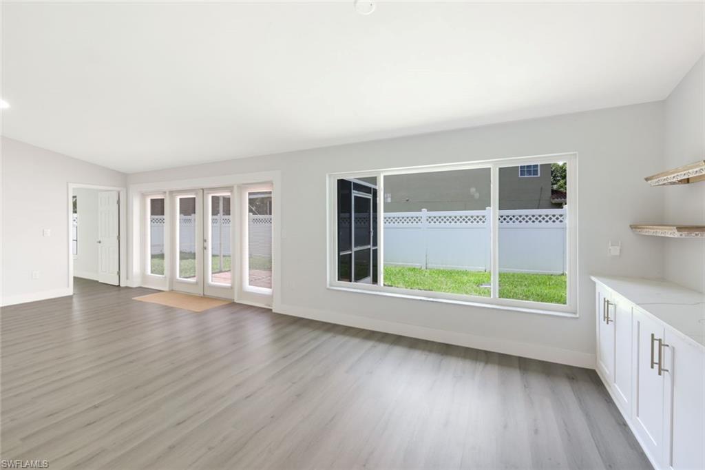 12800 Eagle Pointe Circle Fort Myers, FL 33913 - Photo 15 of 28 a view of an empty room with a window and wooden floor