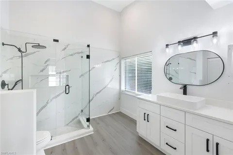 a bathroom with a mirror sink and a mirror