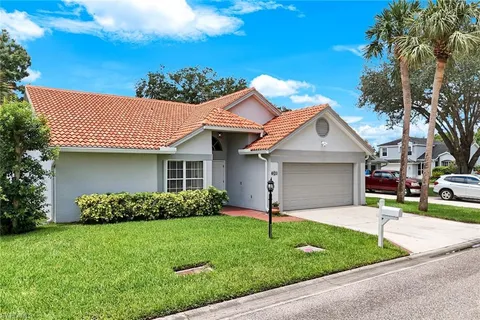 a front view of a house with a garden and plants