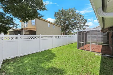 a view of a house with a backyard