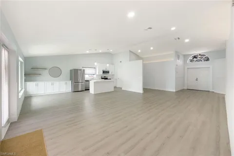 a view of a kitchen with a sink and a large window