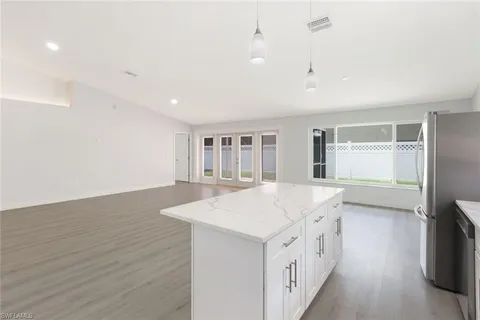 a kitchen with a sink and wooden floor