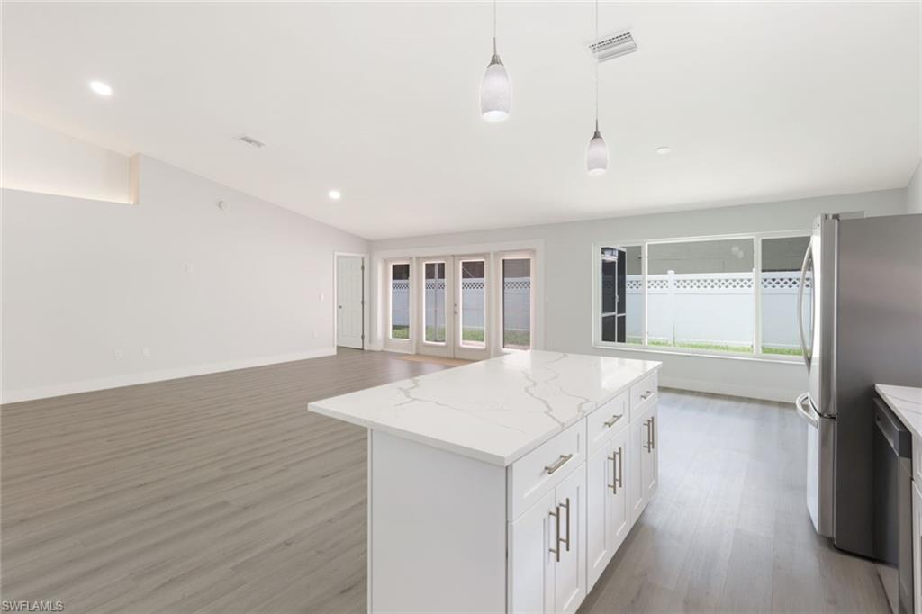 12800 Eagle Pointe Circle Fort Myers, FL 33913 - Photo 10 of 28 a kitchen with a sink and wooden floor