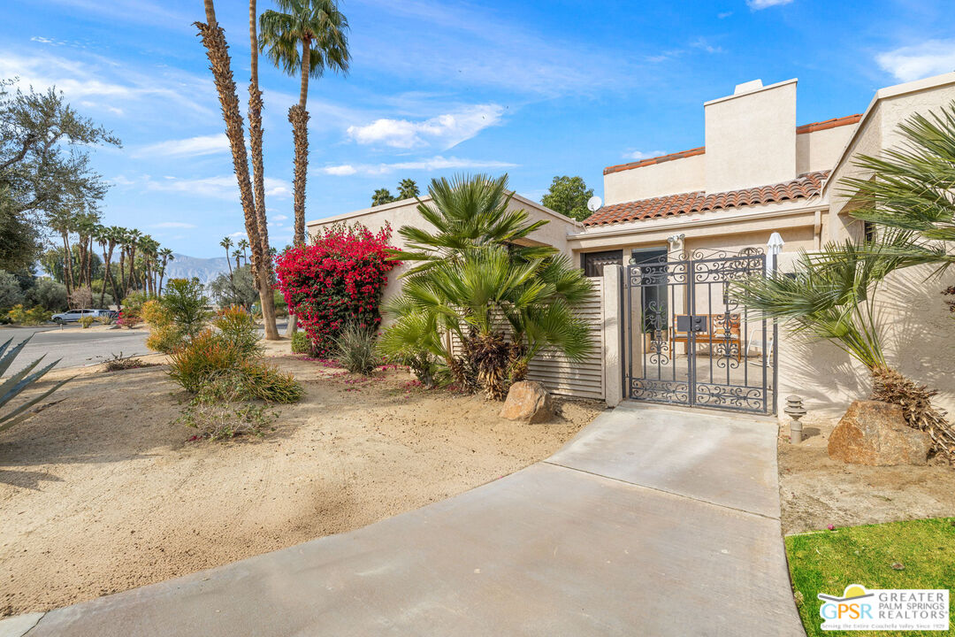 651 Hospitality Drive Rancho Mirage, CA 92270 - Photo 15 of 44 a potted plant sitting in front of a house
