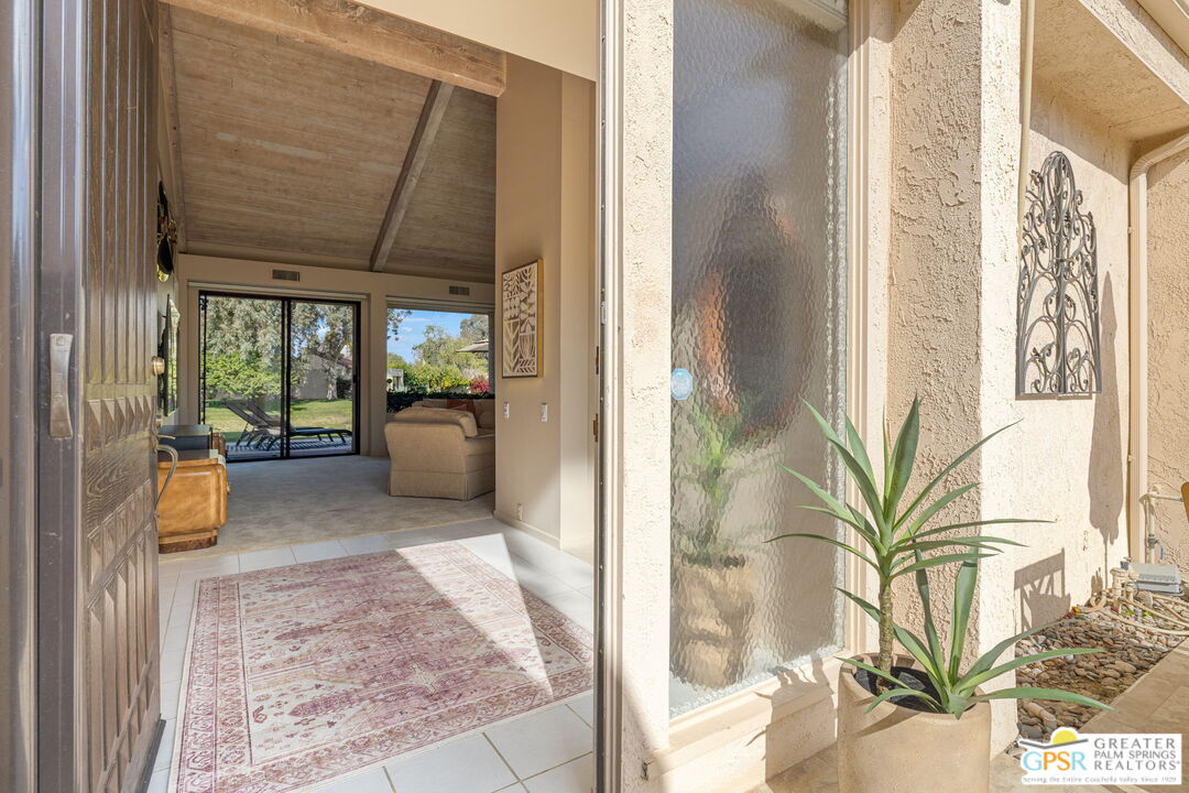 651 Hospitality Drive Rancho Mirage, CA 92270 - Photo 17 of 44 a view of a hallway to a livingroom with furniture
