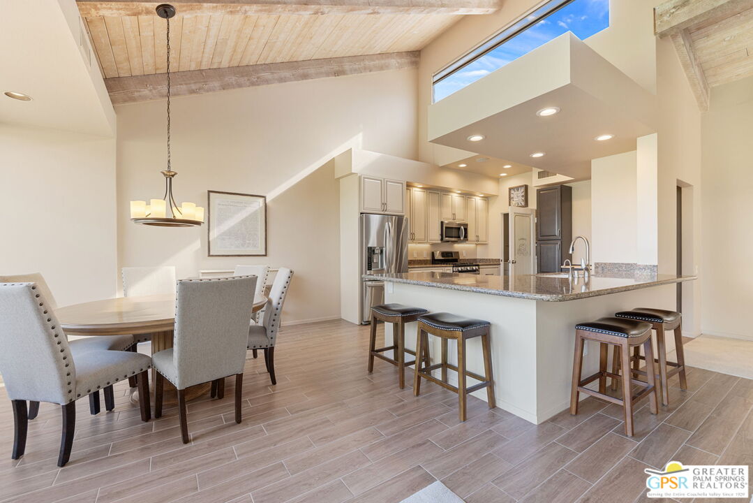 651 Hospitality Drive Rancho Mirage, CA 92270 - Photo 20 of 44 a dining hall with stainless steel appliances a dining table chairs with wooden floor