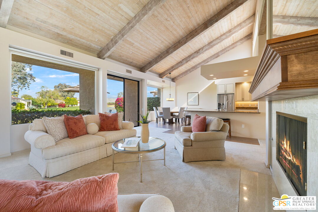 651 Hospitality Drive Rancho Mirage, CA 92270 - Photo 2 of 44 a living room with furniture a fireplace and a large window