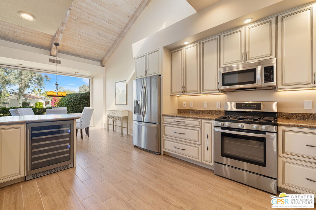 651 Hospitality Drive Rancho Mirage, CA 92270 - Photo 21 of 44 a kitchen with stainless steel appliances a stove microwave and cabinets
