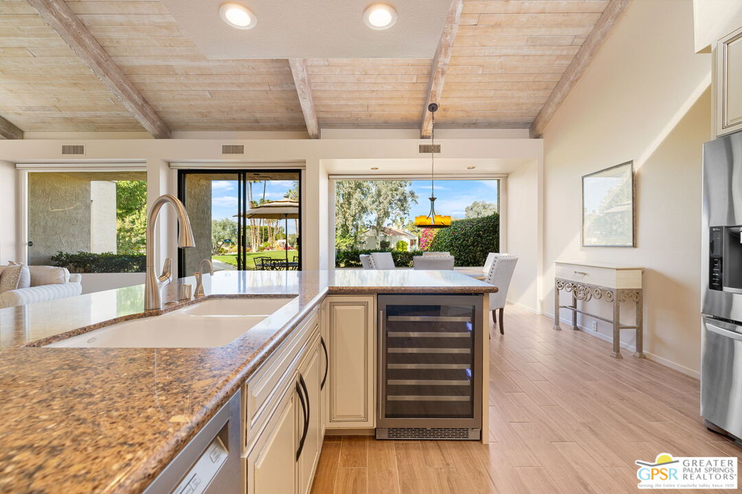 651 Hospitality Drive Rancho Mirage, CA 92270 - Photo 22 of 44 a kitchen with stainless steel appliances granite countertop a stove and cabinets with wooden floor