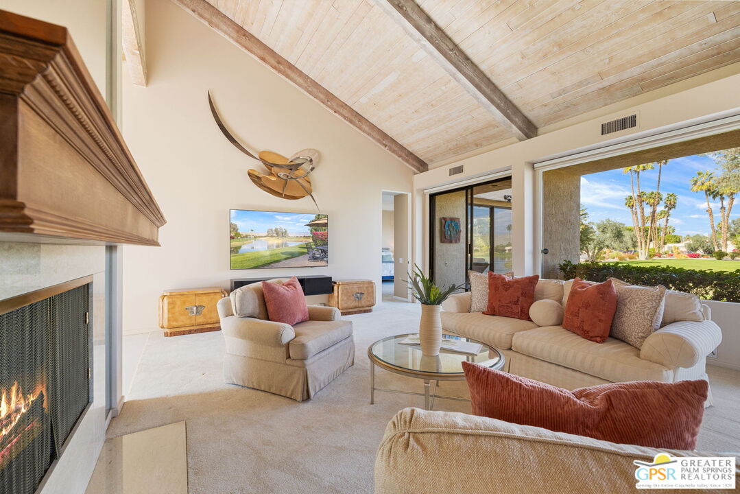 651 Hospitality Drive Rancho Mirage, CA 92270 - Photo 29 of 44 a living room with furniture and a flat screen tv