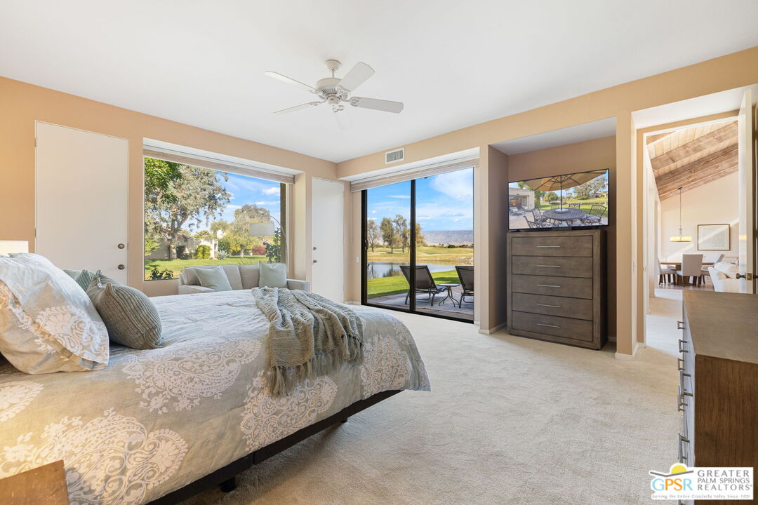651 Hospitality Drive Rancho Mirage, CA 92270 - Photo 30 of 44 a bedroom with a bed and a chandelier
