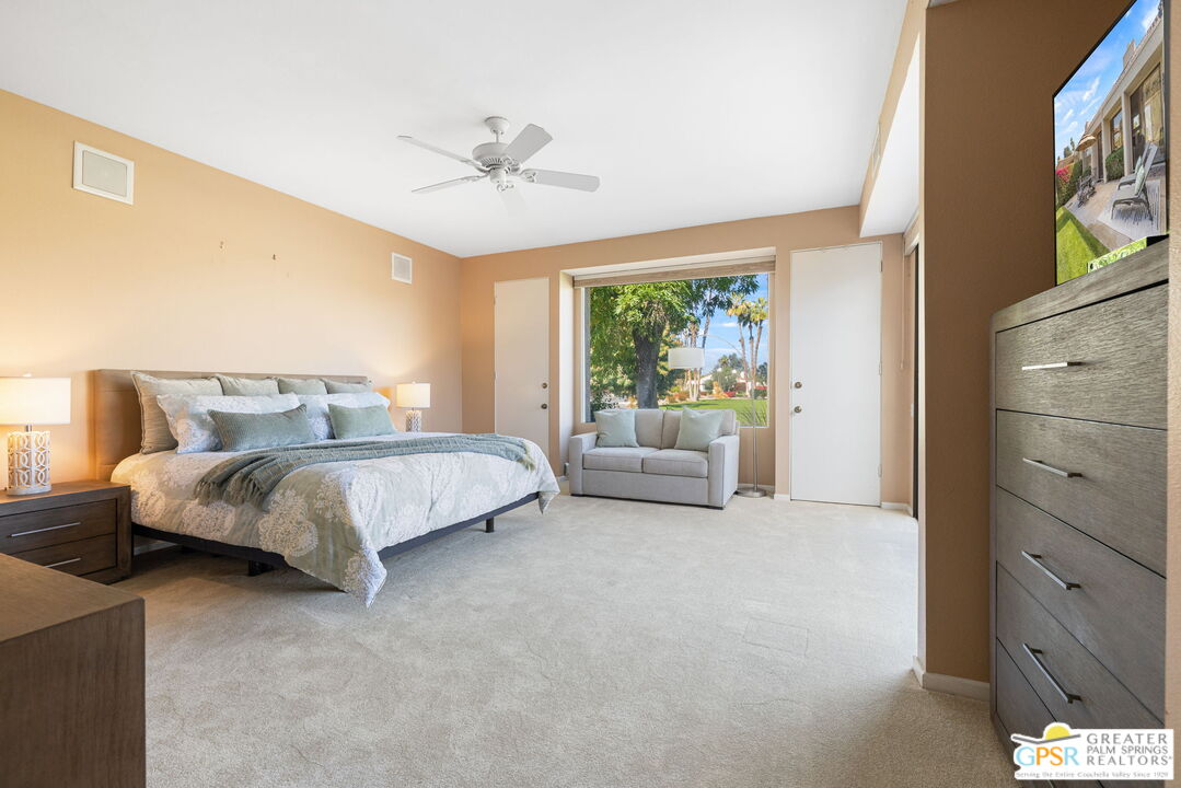651 Hospitality Drive Rancho Mirage, CA 92270 - Photo 31 of 44 a bedroom with a white bed and ceiling fan