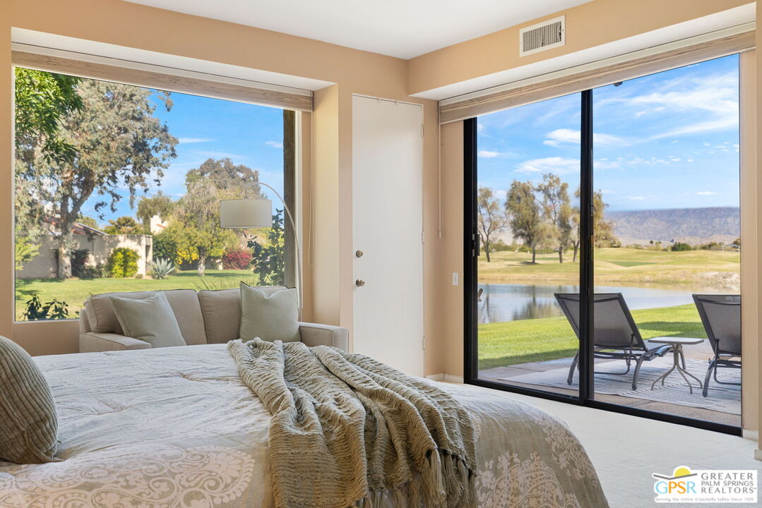 651 Hospitality Drive Rancho Mirage, CA 92270 - Photo 32 of 44 a bedroom with a bed and large windows