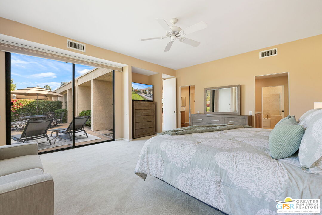 651 Hospitality Drive Rancho Mirage, CA 92270 - Photo 34 of 44 a spacious bedroom with a bed and a large mirror