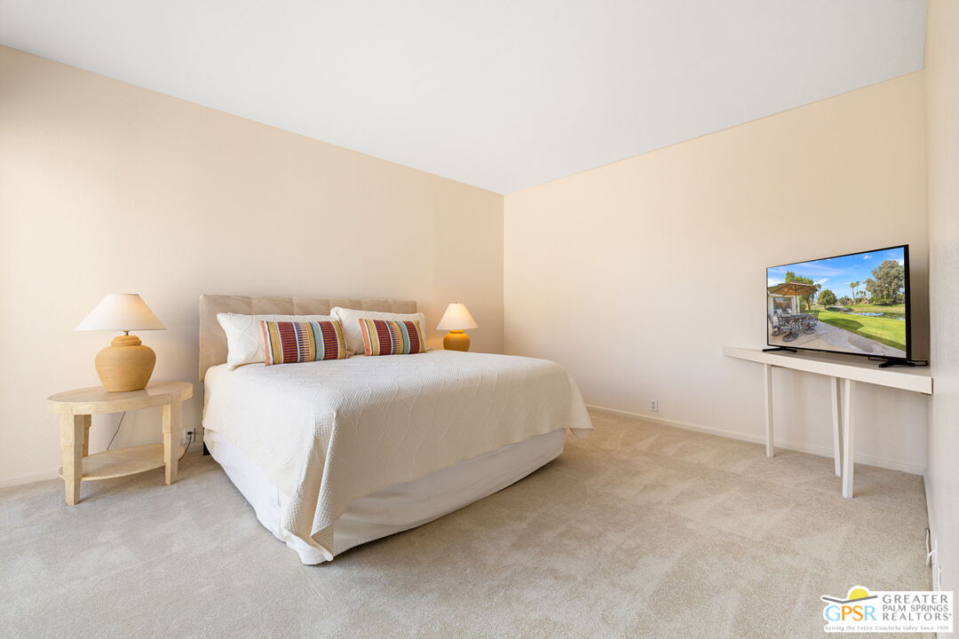 651 Hospitality Drive Rancho Mirage, CA 92270 - Photo 39 of 44 a bedroom with a bed and flat screen tv