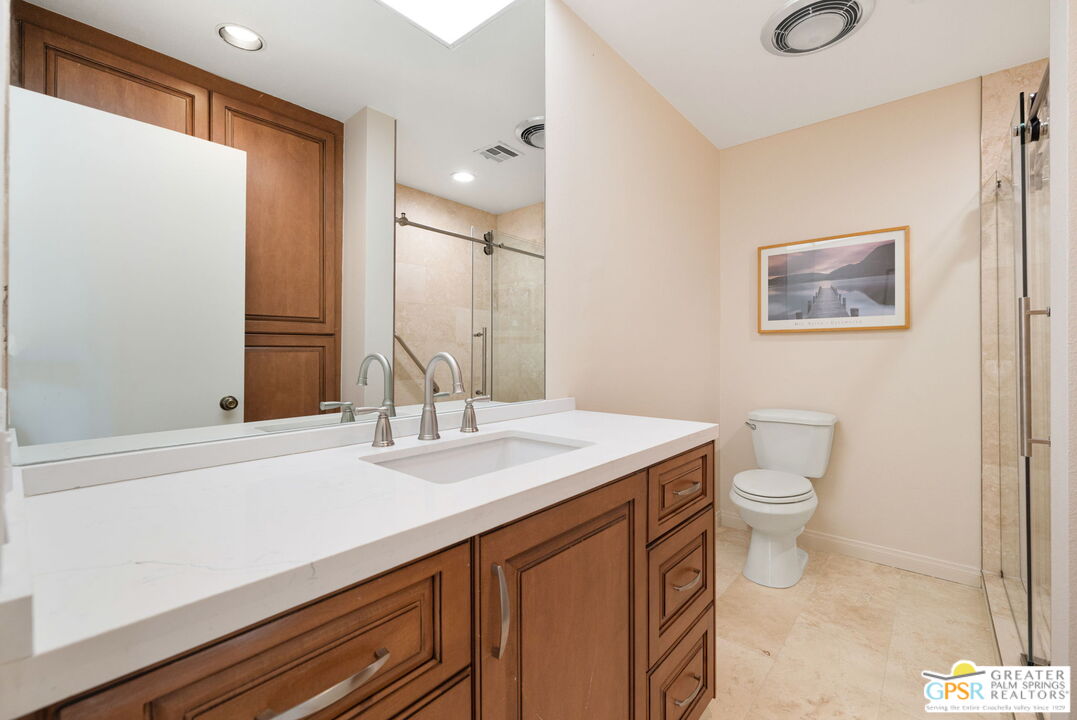 651 Hospitality Drive Rancho Mirage, CA 92270 - Photo 40 of 44 a bathroom with a sink a toilet and mirror