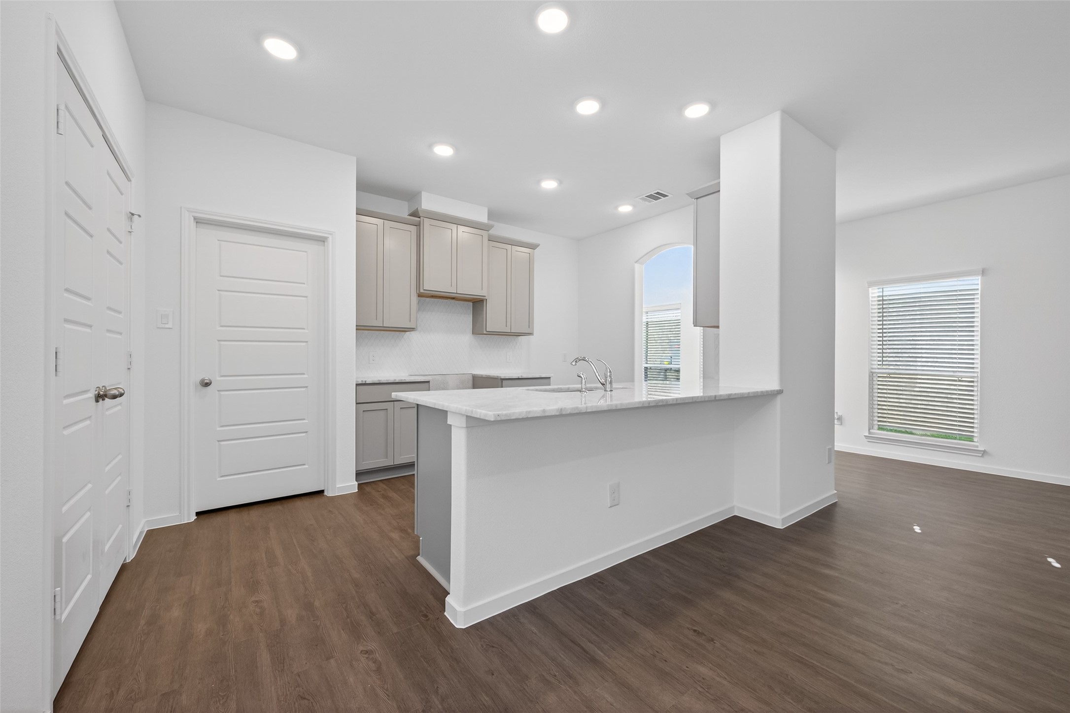 12375 Sunset Canyon Way Willis, TX 77318 - Photo 11 of 40 a kitchen with wooden floors white cabinets and appliances