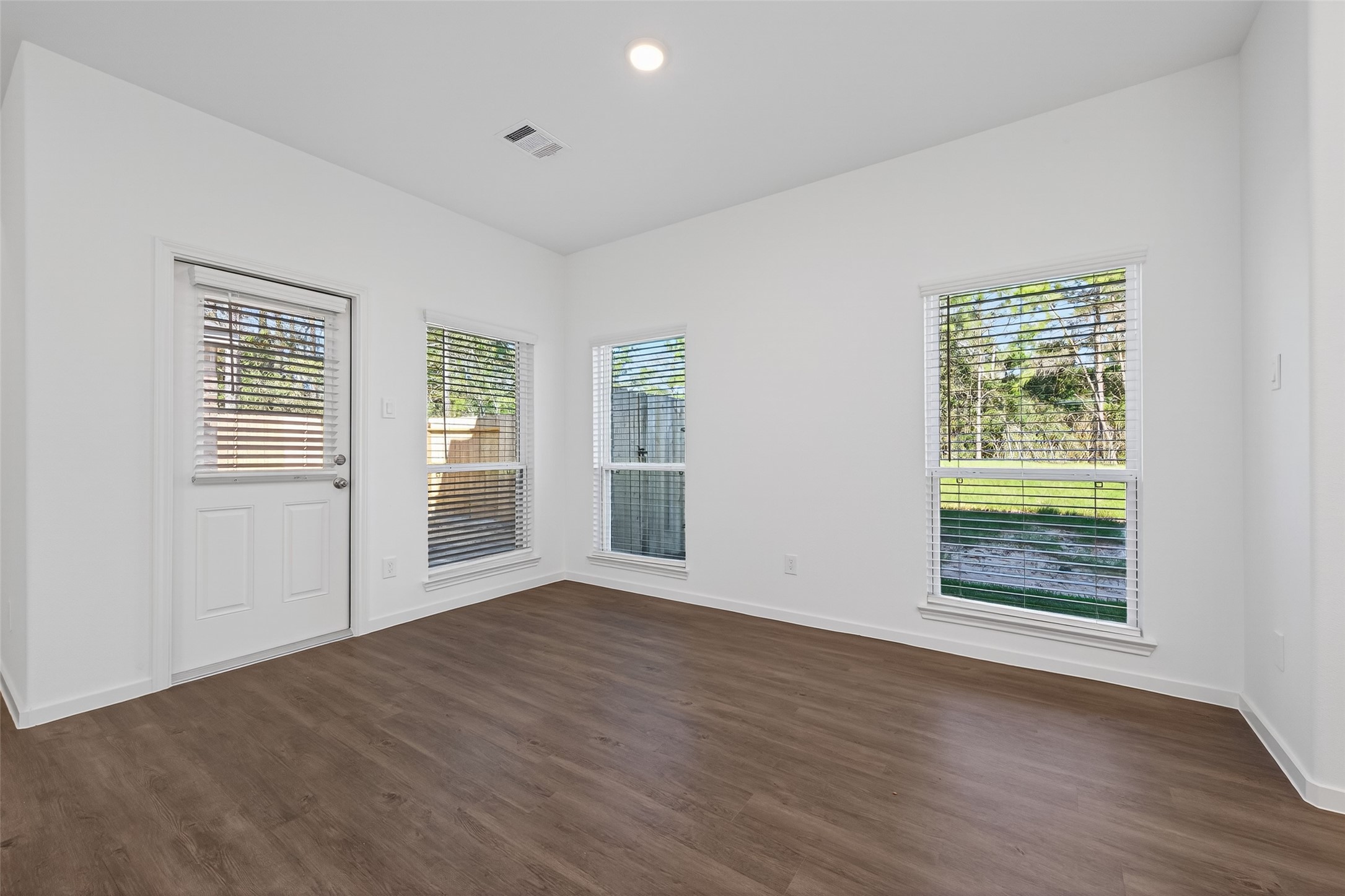 12375 Sunset Canyon Way Willis, TX 77318 - Photo 17 of 40 a view of an empty room with wooden floor and a window