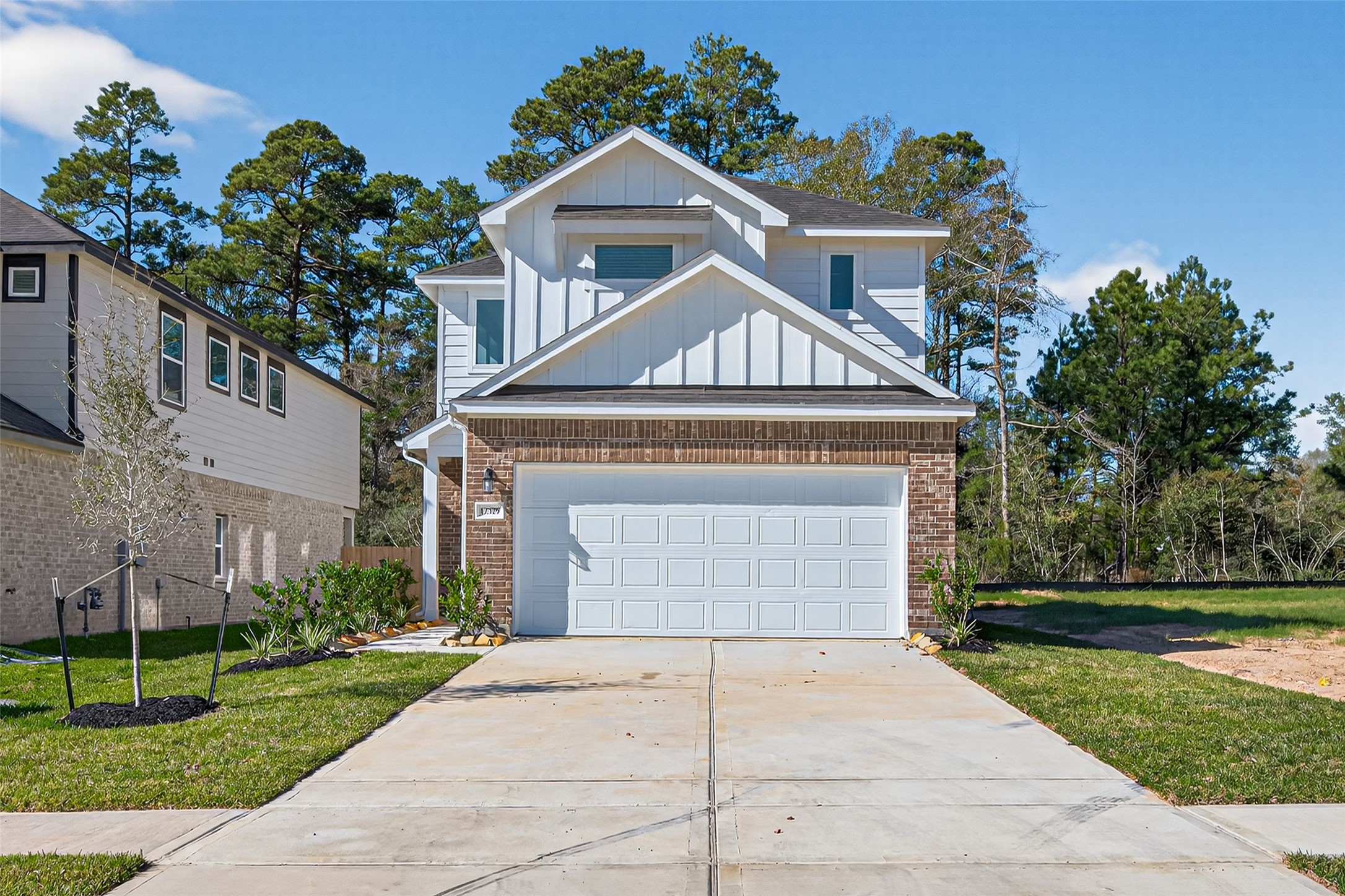 12375 Sunset Canyon Way Willis, TX 77318 - Photo 2 of 40 a front view of a house with a yard and garage