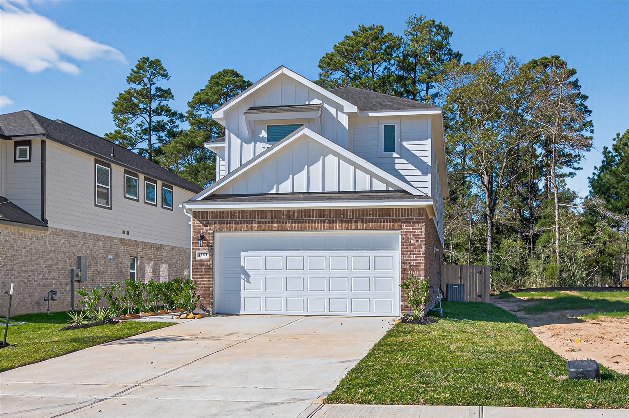 12375 Sunset Canyon Way Willis, TX 77318 - Photo 3 of 40 a front view of a house with a garden and plants