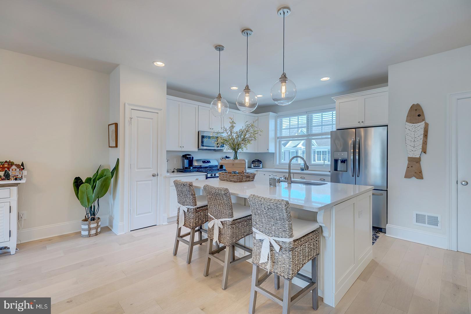 18799 Bethpage Drive, Unit 16E Lewes, DE 19958 - Photo 12 of 68 a large kitchen with a table and chairs