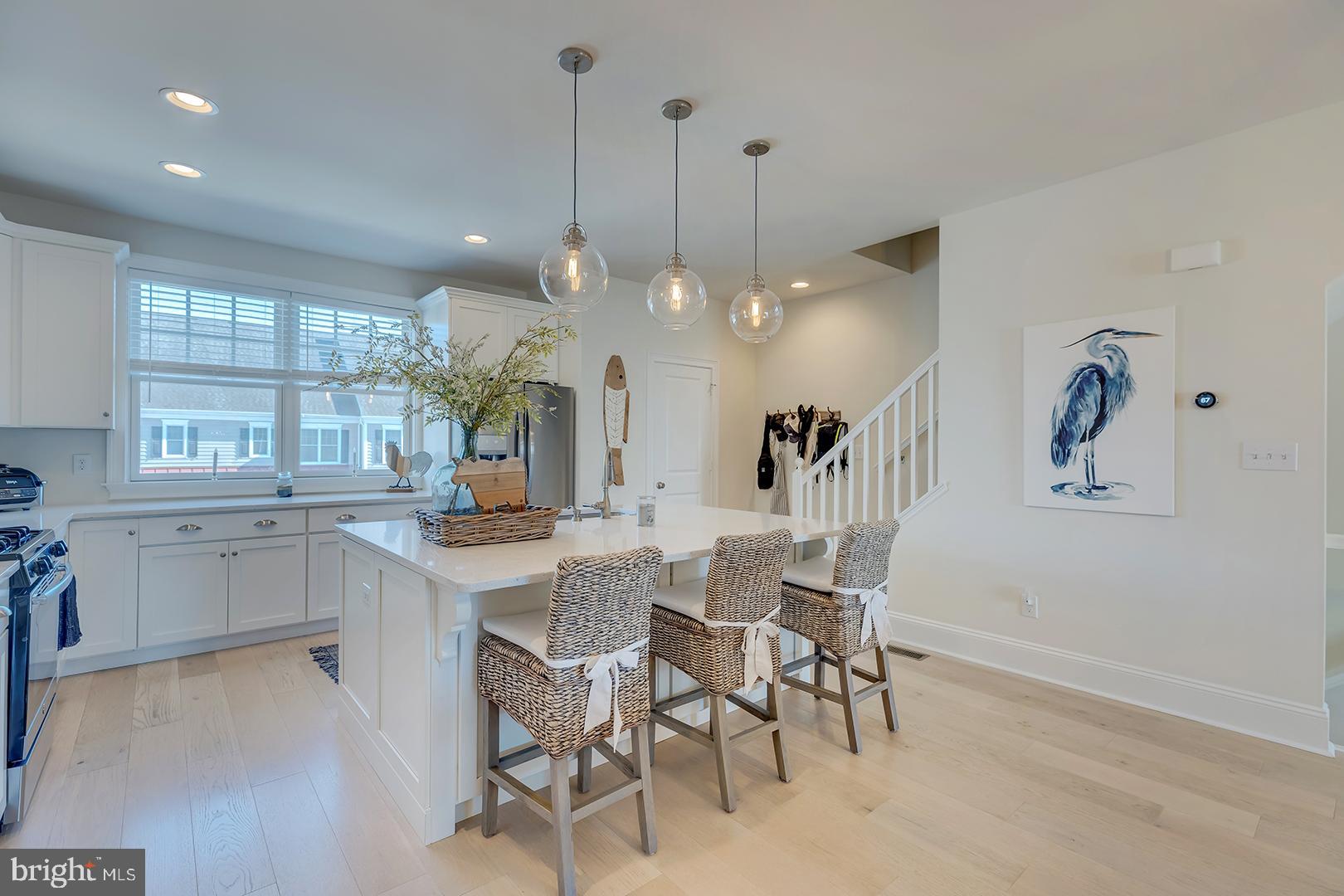 18799 Bethpage Drive, Unit 16E Lewes, DE 19958 - Photo 13 of 68 a kitchen with a dining table chairs and wooden floor