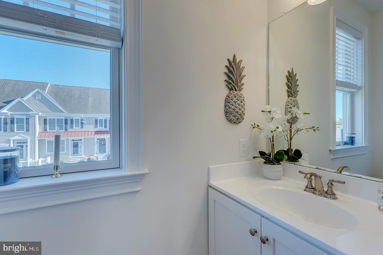 18799 Bethpage Drive, Unit 16E Lewes, DE 19958 - Photo 20 of 68 a bathroom with a sink and a mirror