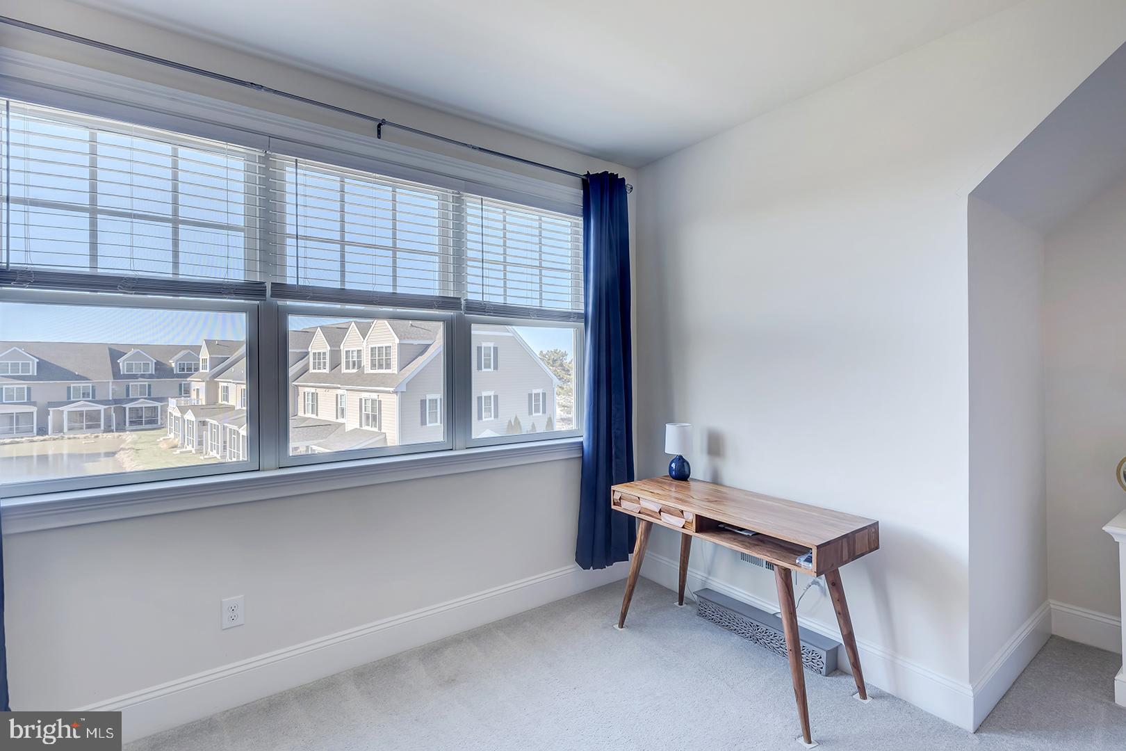 18799 Bethpage Drive, Unit 16E Lewes, DE 19958 - Photo 26 of 68 a living room with furniture and a window