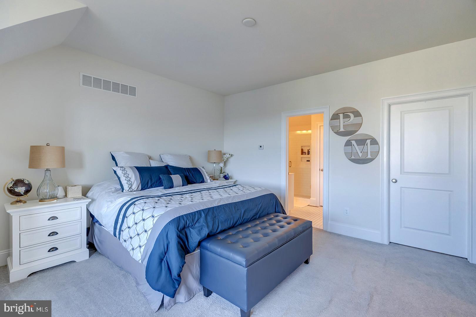 18799 Bethpage Drive, Unit 16E Lewes, DE 19958 - Photo 27 of 68 a bed room with a bed and a lamp