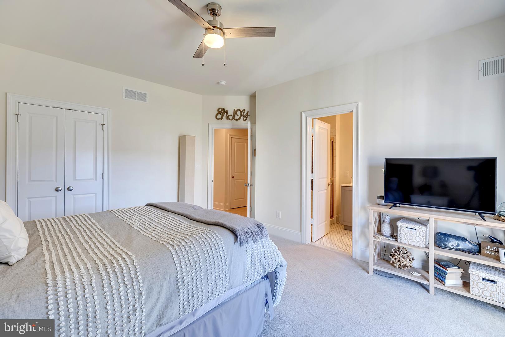 18799 Bethpage Drive, Unit 16E Lewes, DE 19958 - Photo 31 of 68 a bedroom with a bed and a flat screen tv