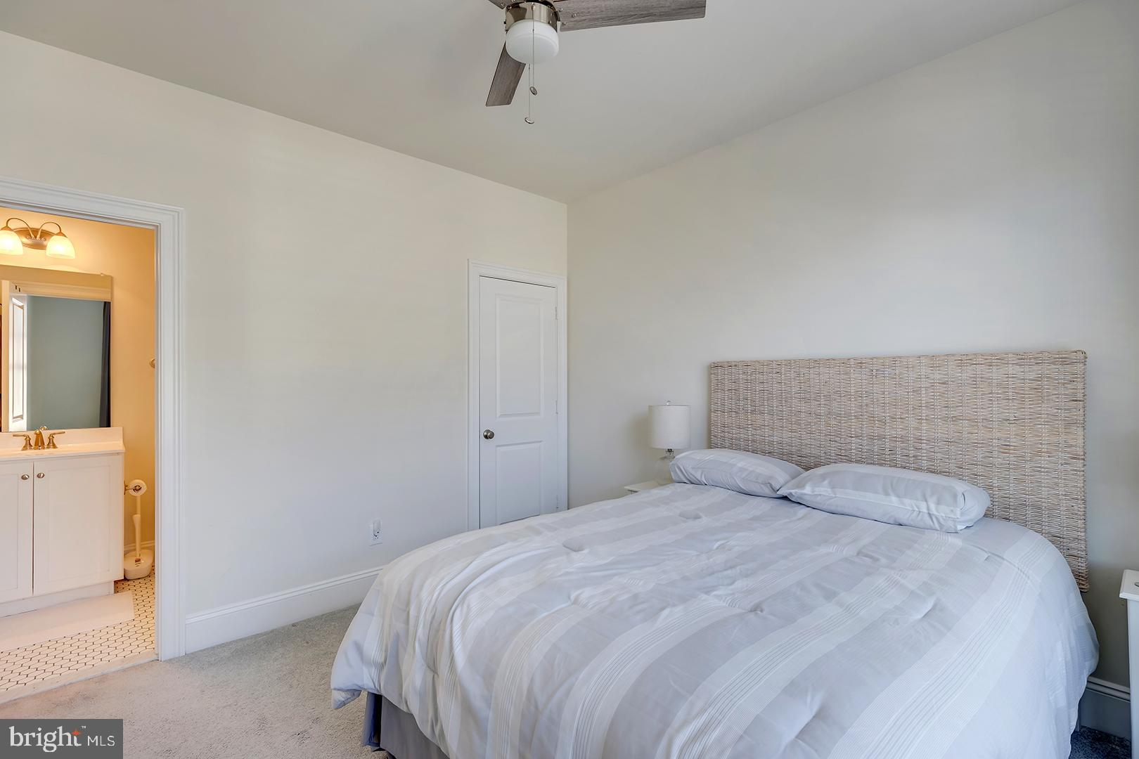 18799 Bethpage Drive, Unit 16E Lewes, DE 19958 - Photo 35 of 68 a bedroom with a bed and a mirror